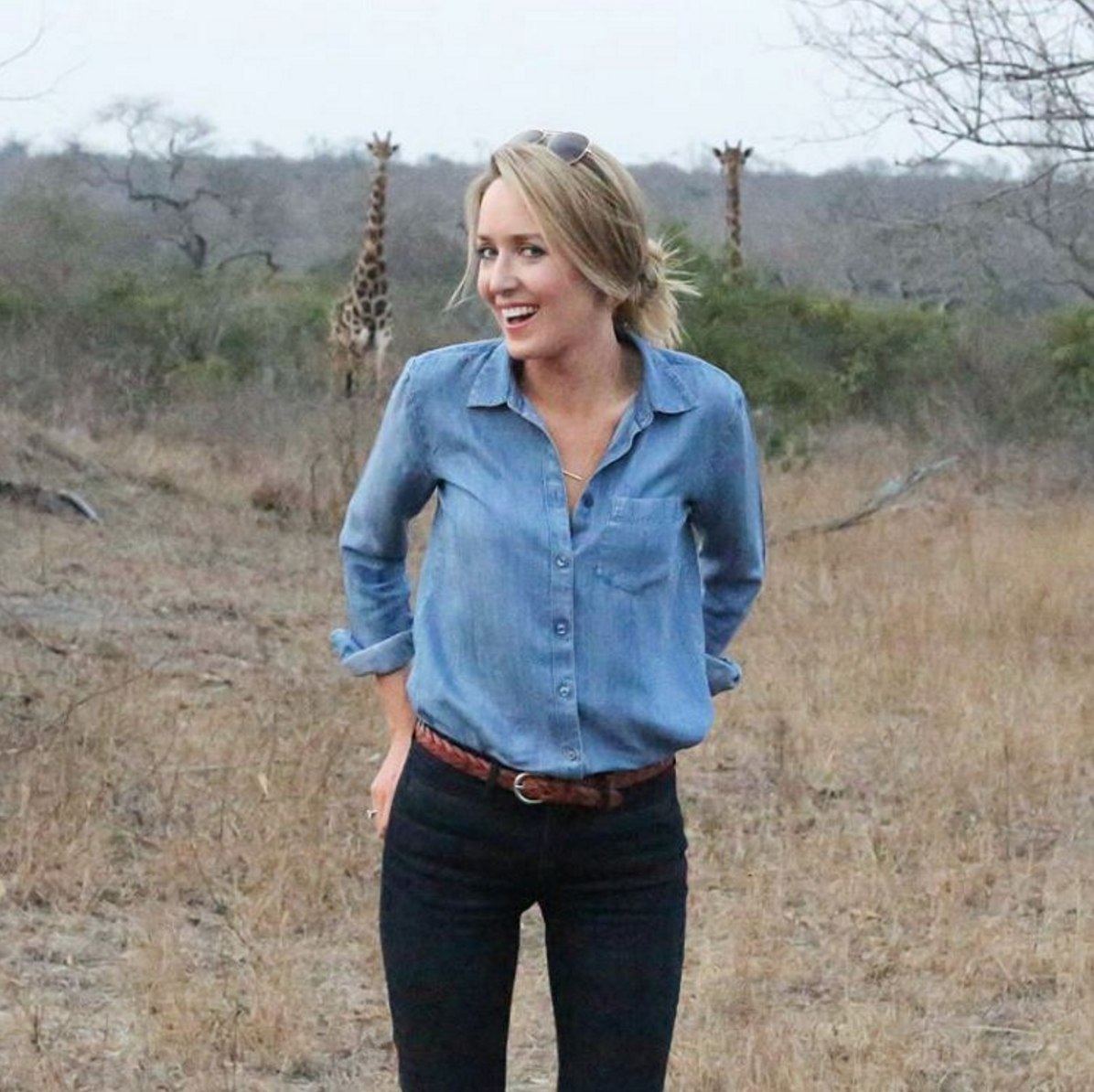 posing with two giraffes