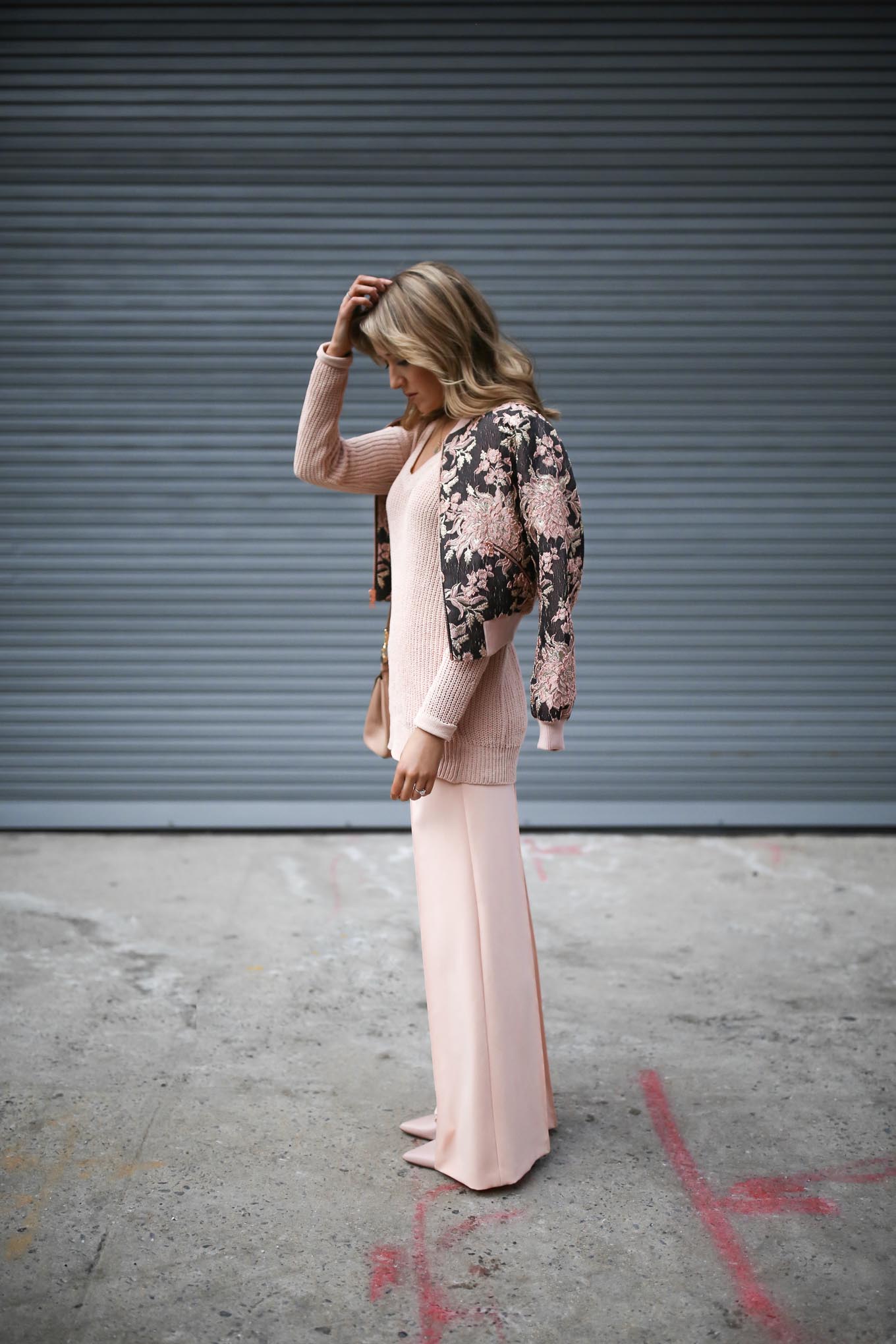 pastel-coral-pink-monochromatic-wide-leg-pants-chunky-knit-v-neck-sweater-jacquard-bomber-jacket-alice-olivia-nyfw-street-style-blog-3