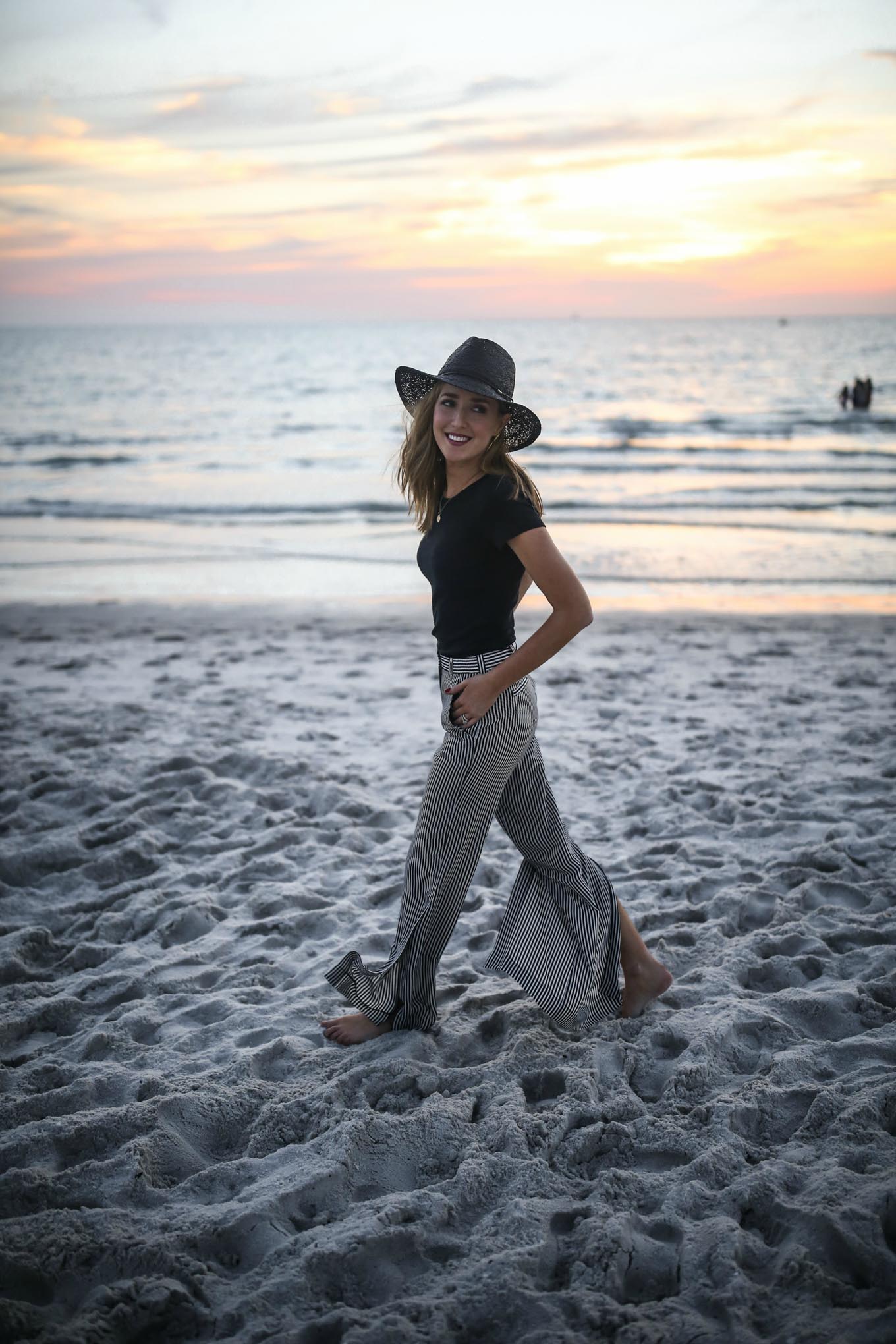 alc-striped-silk-split-leg-pants-black-short-sleeve-shirt-black-straw-wide-brim-fedora
