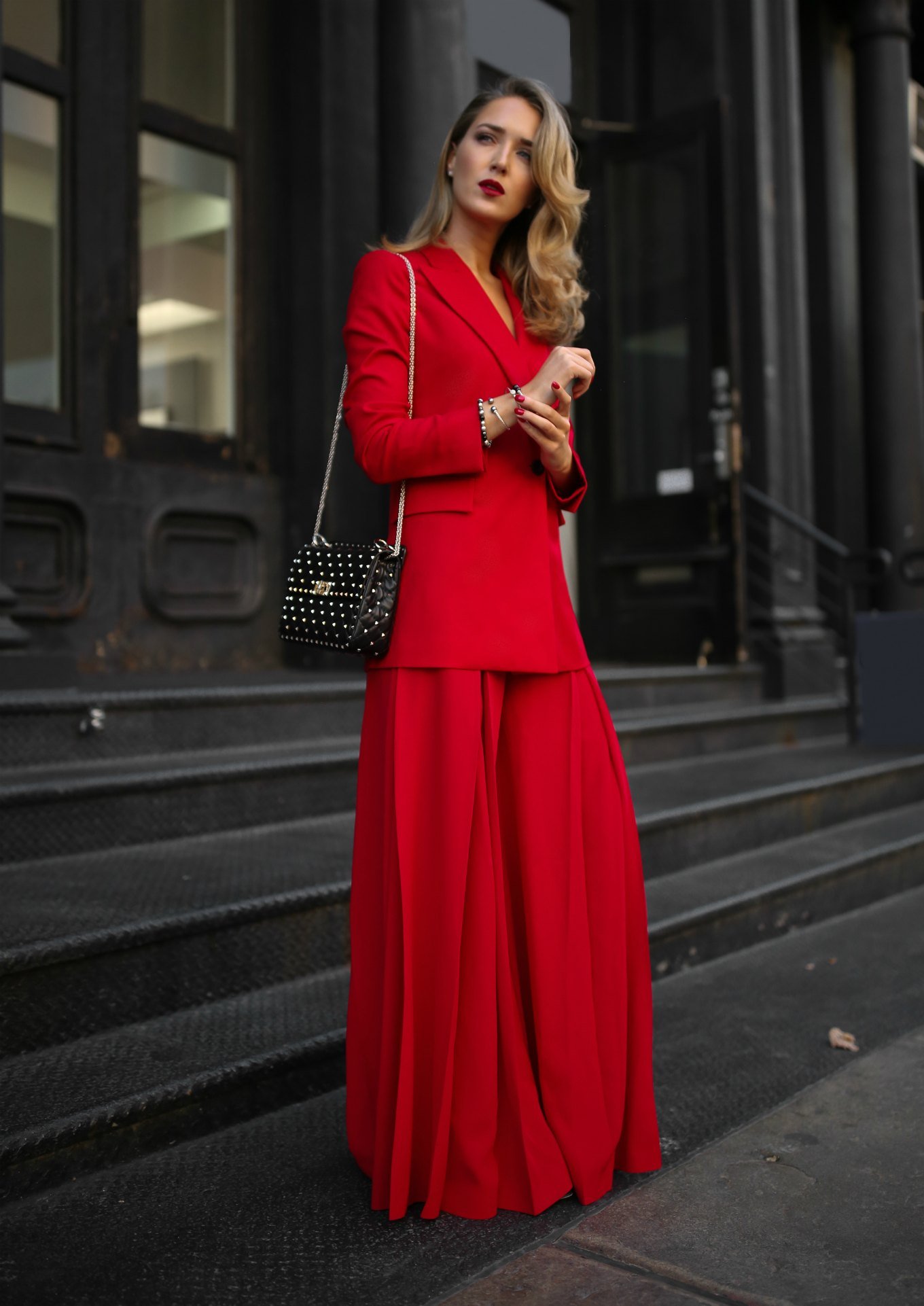 NYC fashion blogger Mary Orton of Memorandum wears a Sara Battaglia red longline blazer, wide-leg pleated red trousers, a black Valentino studded leather shoulder bag, stacked David Yurman Solari bracelets and David Yurman pave stud earrings
