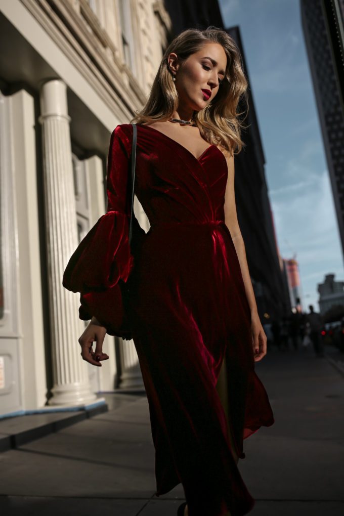 NYC fashion blogger Mary Orton wears a Johanna Ortiz red velvet asymmetrical dress and a gold choker for a night at the theater