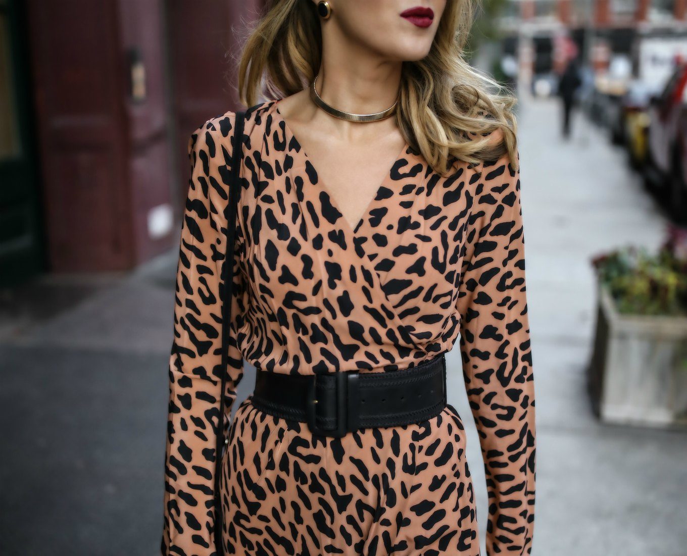 Mary Orton of Memorandum wears a long sleeve leopard print DVF wrap dress, a black waist belt and a gold choker