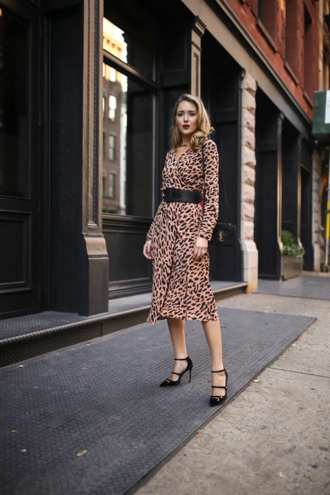 NYC fashion blogger Mary Orton of Memorandum wears a long sleeve leopard print DVF wrap dress, a black waist belt and black pumps