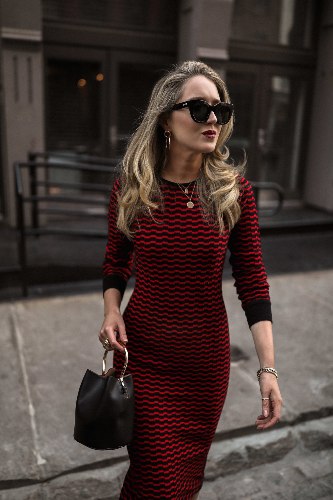 NYC style blogger in black red knit dress and gold jewelry