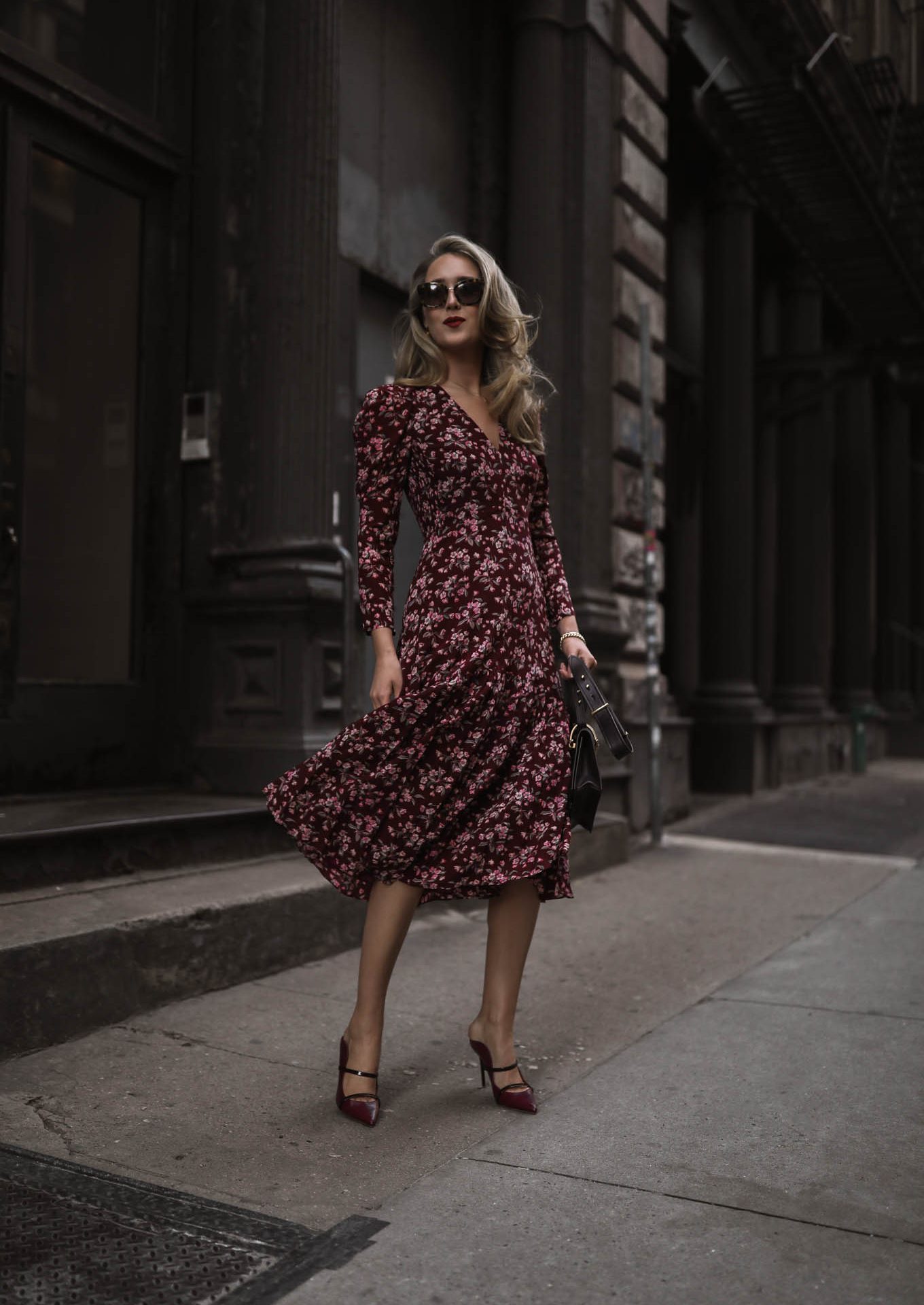 NYC style blogger wears red pink floral midi dress with red heels, bag and sunglasses