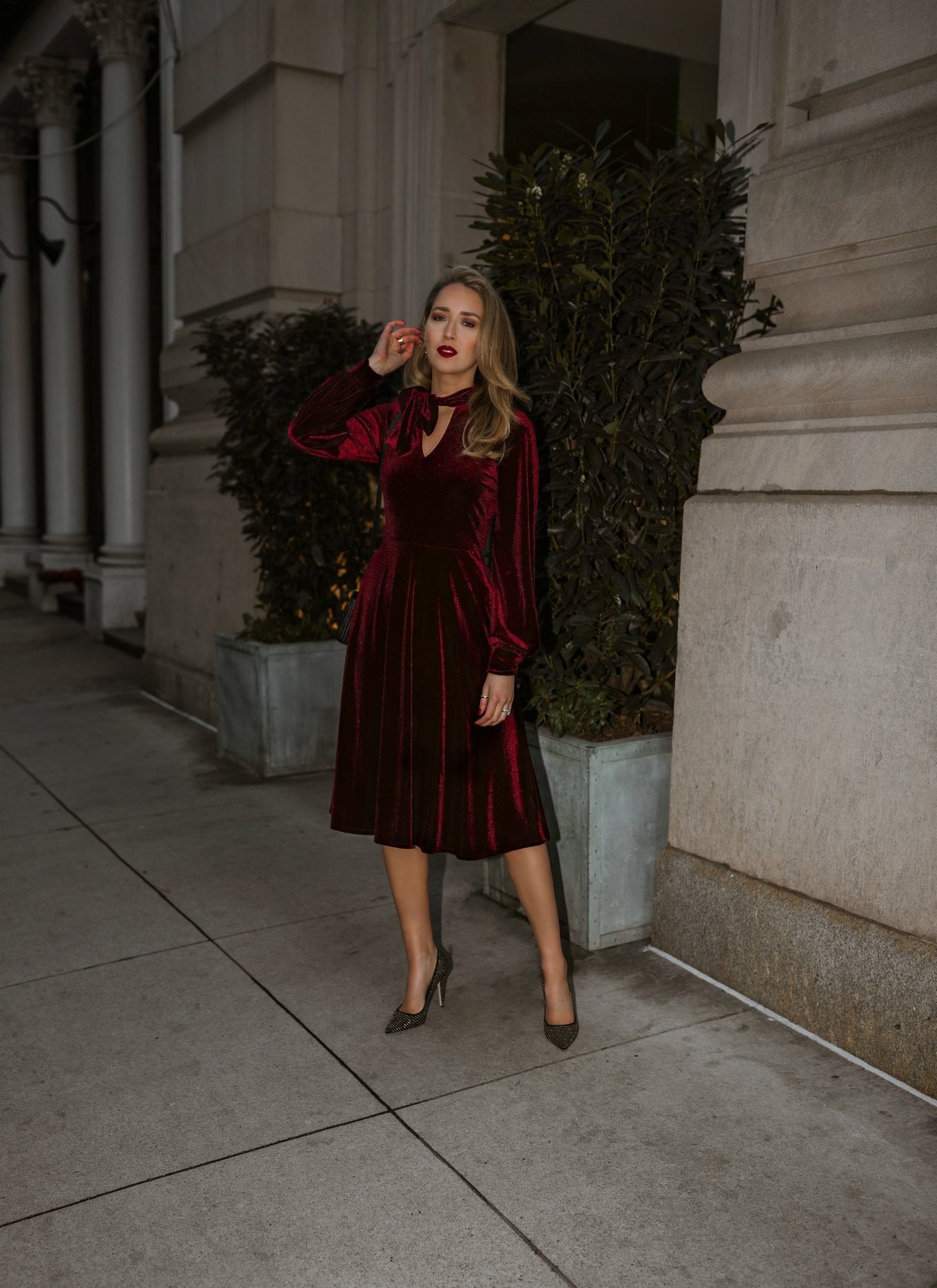 NYC style blogger Mary Orton in a red velvet midi dress and heels